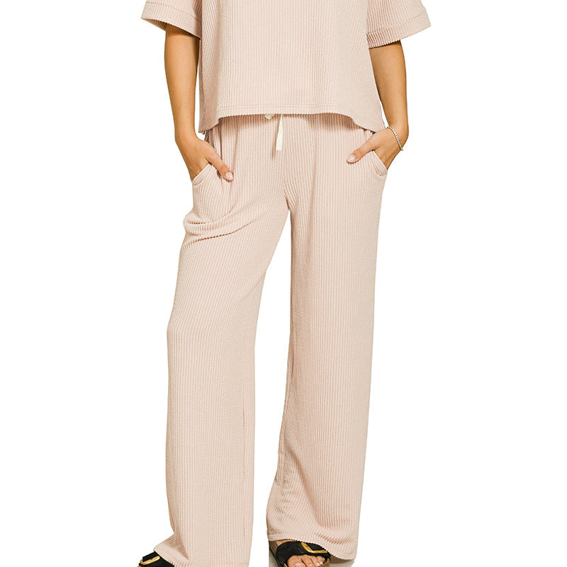 Woman wearing a sand beige outfit on a white background