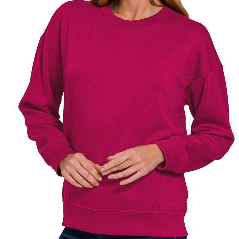 Woman wearing a bright pink sweatshirt with 'CABERNET' text on a white background