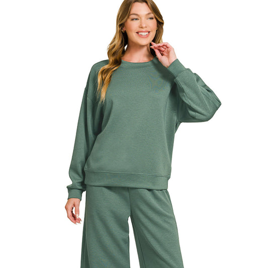 Woman wearing a green lounge set on a white background